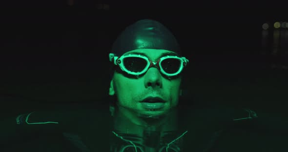 Portrait of Triathlon Athlete Swimmer Having a Break During Intense Training at Night alt