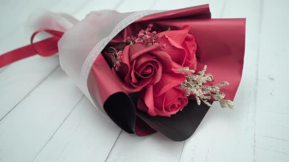 A bunch of flowers lying on the white wooden table.Valentine’s celebration concept.