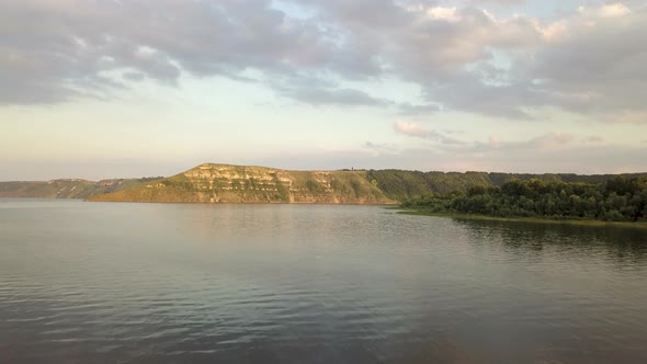 Aerial view of wide Dnister river and distant rocky hills in Bakota area, part of the National park alt