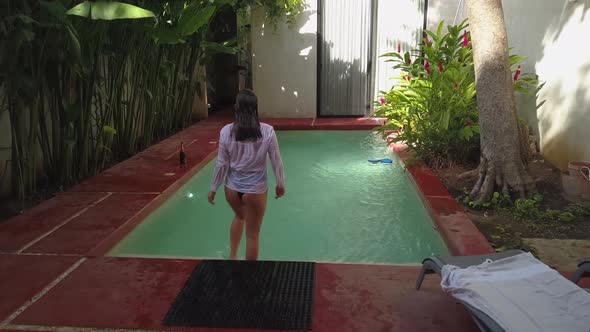 Sexy Woman Jumping in Swimming Pool at Luxury Villa Enjoying Swim at Tropical Resort