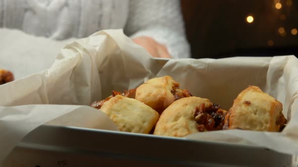 Female Hands Taking Christmas Cookies From a Baking Tray and Putting It in Box alt