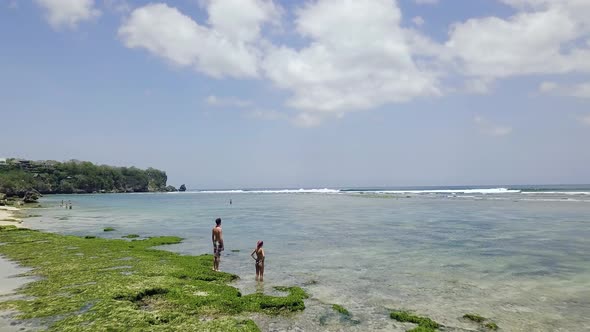 Drone Fly Over Coastal Beach on Summer Day Few Tourist Relaxing in the Shore alt