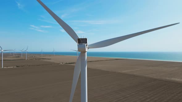 Aerial Zoom Out View of Wind Turbine Farm on Agriculture Fields in Ukraine alt