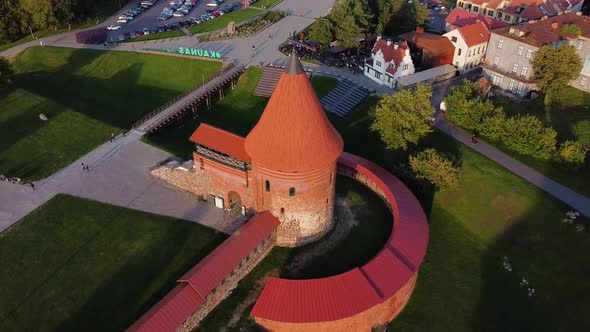 Aerial footage of Kaunas castle, situated in Kaunas old town, Lithuania in beautiful sunny evening. alt
