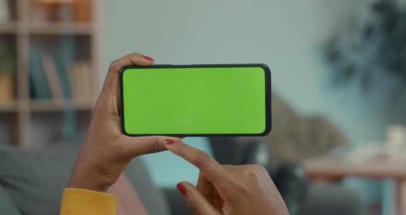 Close Up of Woman Scrolling on Green Screen of Mobile
