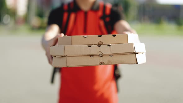 Delivery Man Holding Cardboard Pizza Box Against City Courier Food Delivery