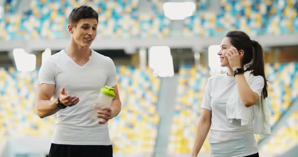 Athletic Couple Walking on Stadium