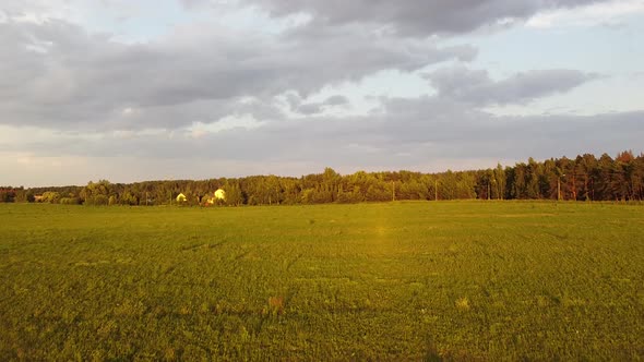 Drone flying up and forward revealing landscape at sunset