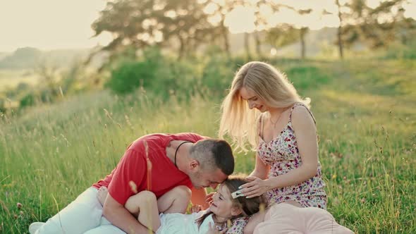 Young married couple with cute little daughter having fun together.