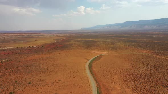 Desert Dirt Road In The Middle Of Nowhere In Utah. - Aerial Drone Shot alt