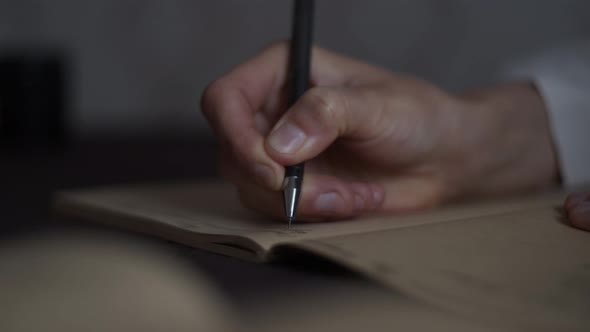 Сlose-up view of female hand making notes writing letter in sketchbook, diary. Education, To do list alt