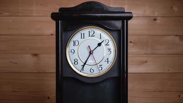 Timelapse of Vintage Clock on Wooden Background with Movement of Time Hands alt
