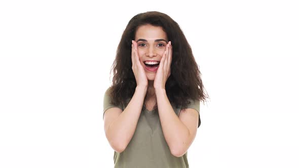 Portrait of Happy Hispanic Woman 20s Emotionally Reacting and Grabbing Her Face After Listening alt