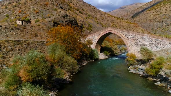 Stream and historical bridge in autumn. alt