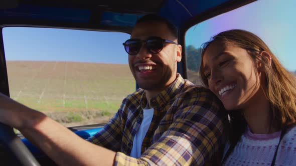 Young couple on a road trip in their pick-up truck alt