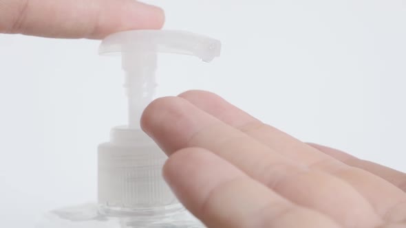 Slow motion  extraction of sanitizer gel from plastic  bottle close-up footage alt
