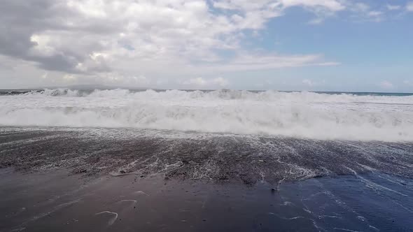 Big Ocean Waves Breaking the Shore of Black Volcanic Beach. Slow Motion View.