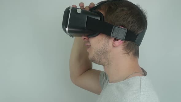 Man Is Testing A Modern Helmet Of Virtual Reality