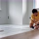 Father and His Little Son Install Laminate on the Floor in Their Apartment - VideoHive Item for Sale