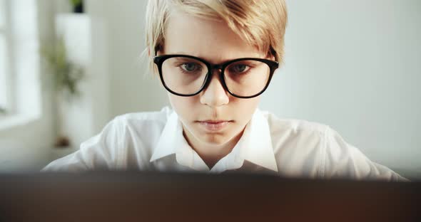 Young Boy Studying on Laptop Closeup