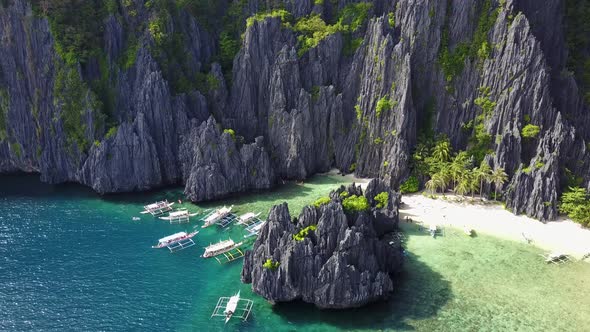 Aerial View of Secret Lagoon with Karst Cliffs and White Beach. El-Nido, Philippines