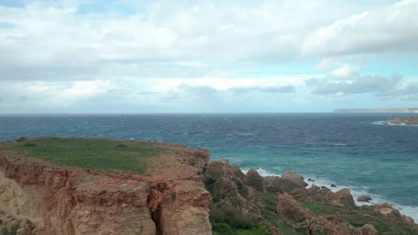 AERIAL: Beautiful Blue Sky with Mediterranean Sea near Il-Qarraba Rock in Malta