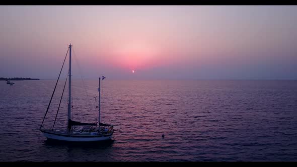 Aerial drone shot scenery of relaxing lagoon beach time by blue sea with bright sandy background of  alt