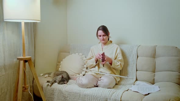 Woman musician with empty wallet no money at home on sofa in living room
