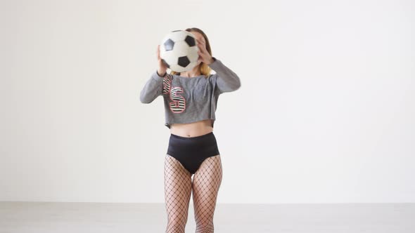 Dancehall Girl Smiling and Dancing with Soccer Ball in Studio alt