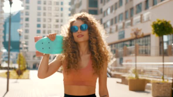 Closeup portrait of beautiful smiling model with afro curls hairstyle posing outdoors alt