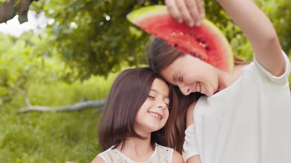 Portrait of Two Cute Girls in Casual Summer Dress Standing Face to Face with alt