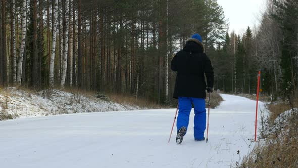 Man Walks Outdoors On Winter Road Winter Forest, Countryside.