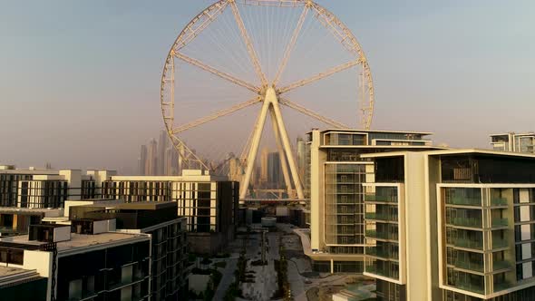 Aerial view passing by of the Ferris wheel under construction, Dubai. alt
