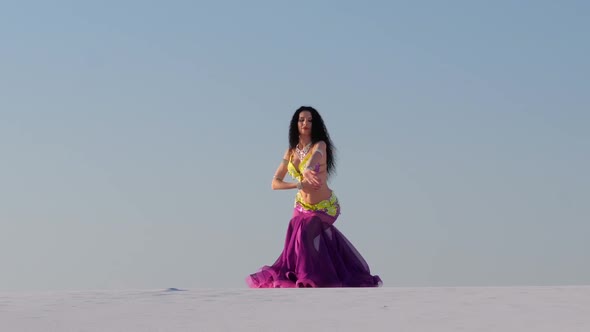Graceful Dancer Against the Sky Dancing Belly Dance in a Brilliant Outfit alt