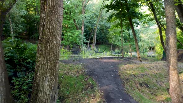 Leafy public park with walking paths and stream