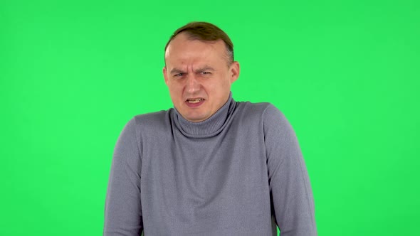Portrait of Male Is Showing Disgust for Bad Smell or Taste. Green Screen alt