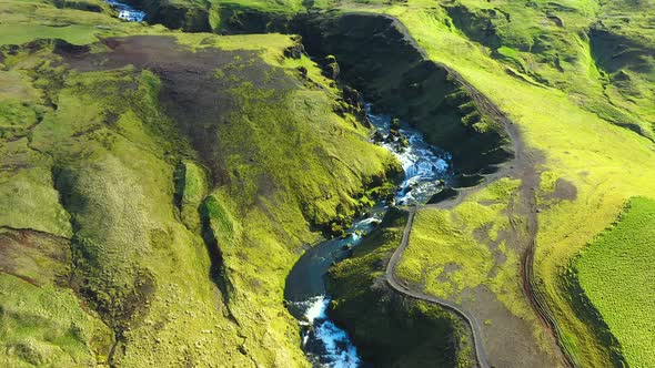 Flying Over the Wild Mountain Skogar River Under the Eyjafjallajokull Volcano in Southern Iceland alt
