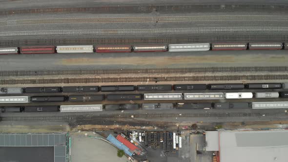 Top Down Aerial of Train Cars Parked in Railway Station alt