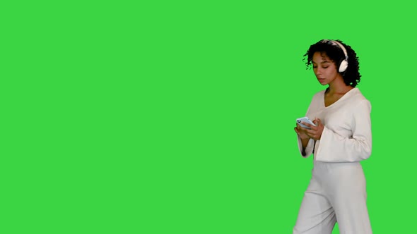 Young Black Lady in White Grooving To Music on a Green Screen Chroma Key alt