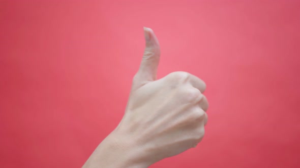 Woman Gives a Thumbs Up on an Isolated Red  Background