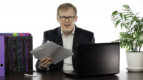 Businessman Working in Office. Negative Amazed of Reading Paper Full of Mistakes alt