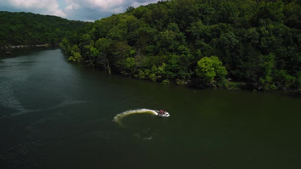 Aerial Photography is an Epic Shot of Jet Ski Racing on a Large River alt