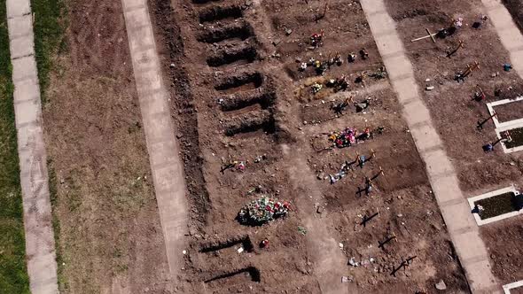 Open Graves Near A City Drone