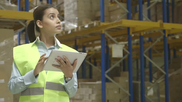 MS Young woman engineer using digital tablet in factory