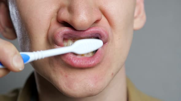 Close Up Head Shot Young Man Brushing Teeth in Bathroom alt