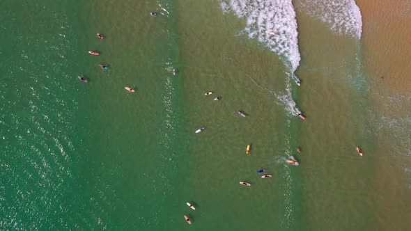 Aerial View Of Surfers Surfing On A Sunny Summer Day In Noosa Heads, QLD, Australia. alt