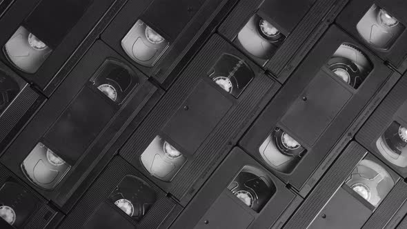Background of real VHS cassettes sliding to the right, black and white alt