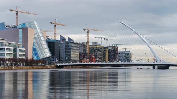 Time lapse of daytime road traffic and people walking by on Samuel Beckett bridge in Dublin City in alt