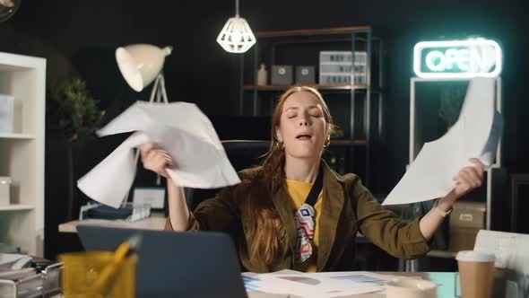 Satisfied Hipster Girl Finishing Project Indoors. Businesswoman Throwing Papers. alt