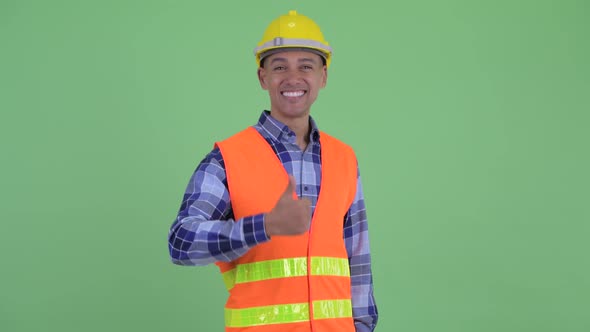 Happy Multi Ethnic Man Construction Worker Giving Thumbs Up alt
